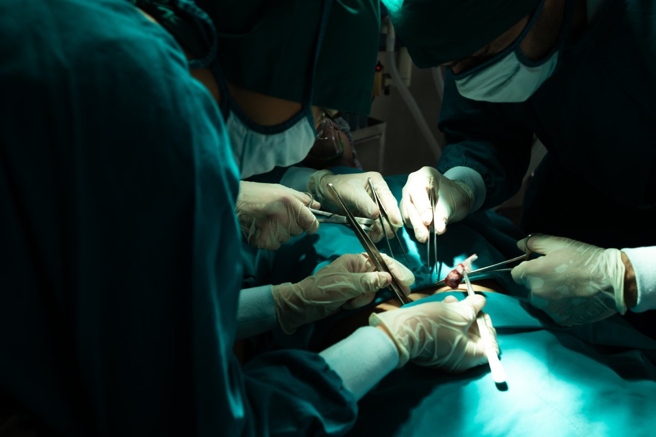 A group of surgeons performing surgery on a patient.