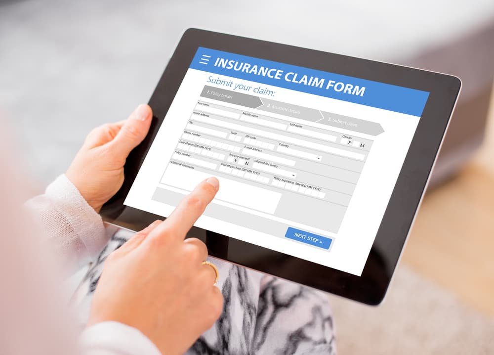 person filling out online car accident claim form
