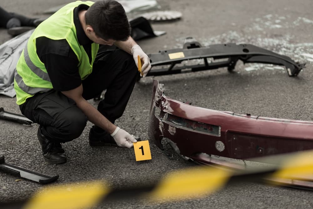 Photo of policeman working at scene after Truck Accident