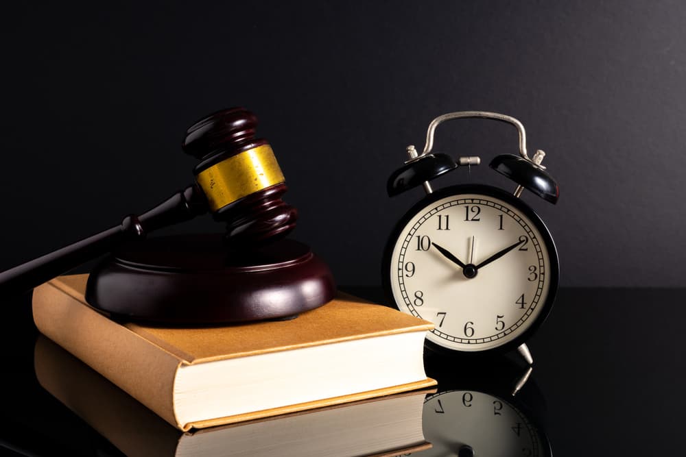 Gavel on the book and a clock on the table